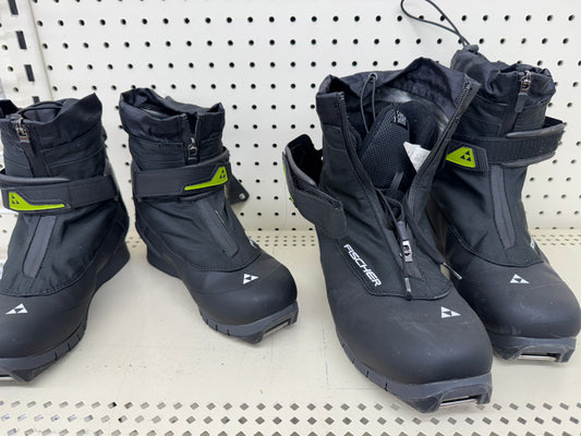 Pair of black ski boots with green accents 